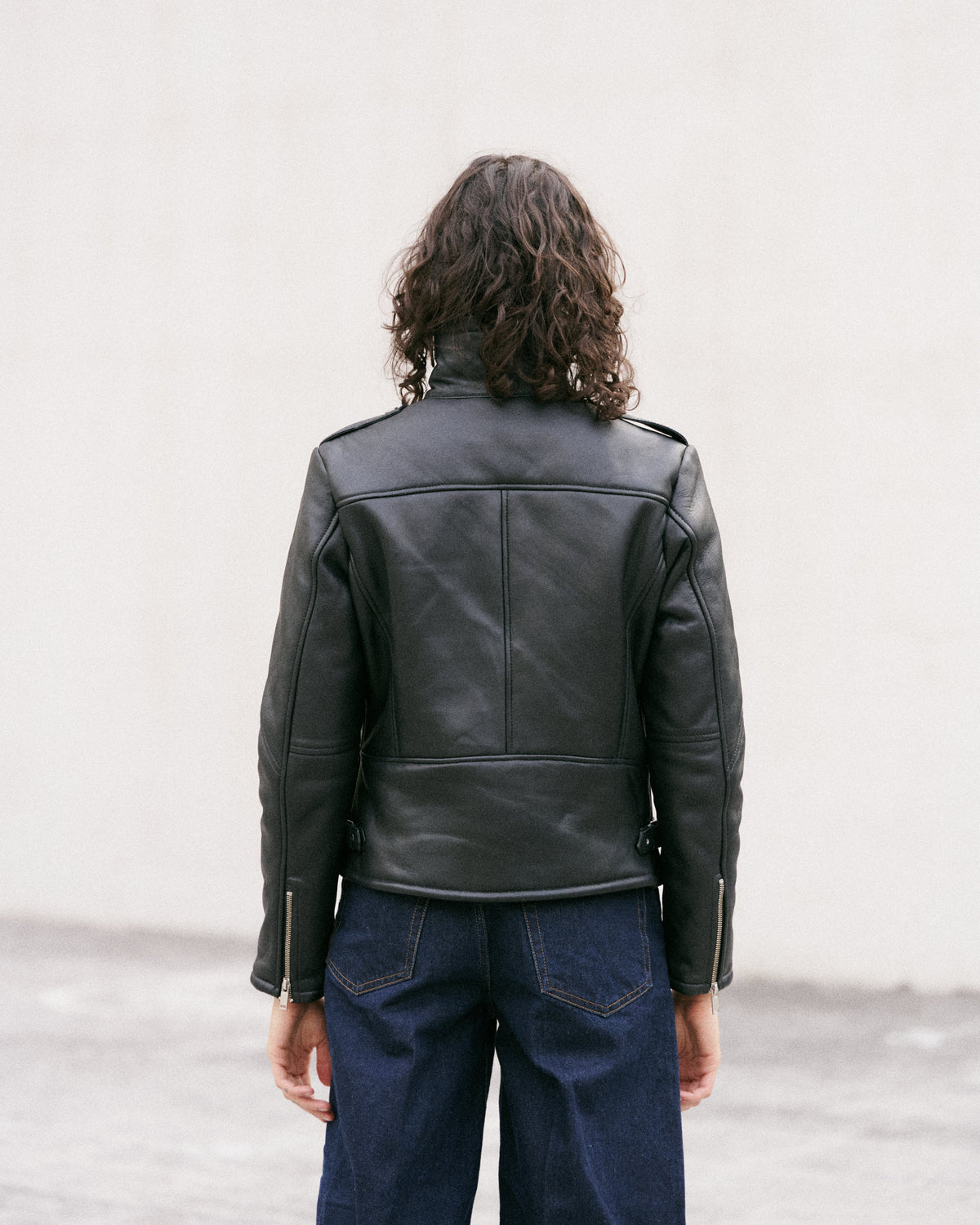 Élégant blouson court noir en cuir doublé de peau lainée