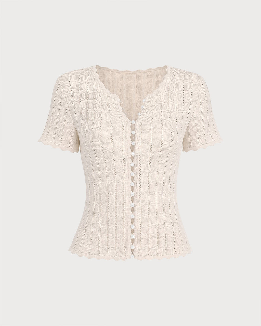 Pull en maille couleur abricot à découpes et boutons