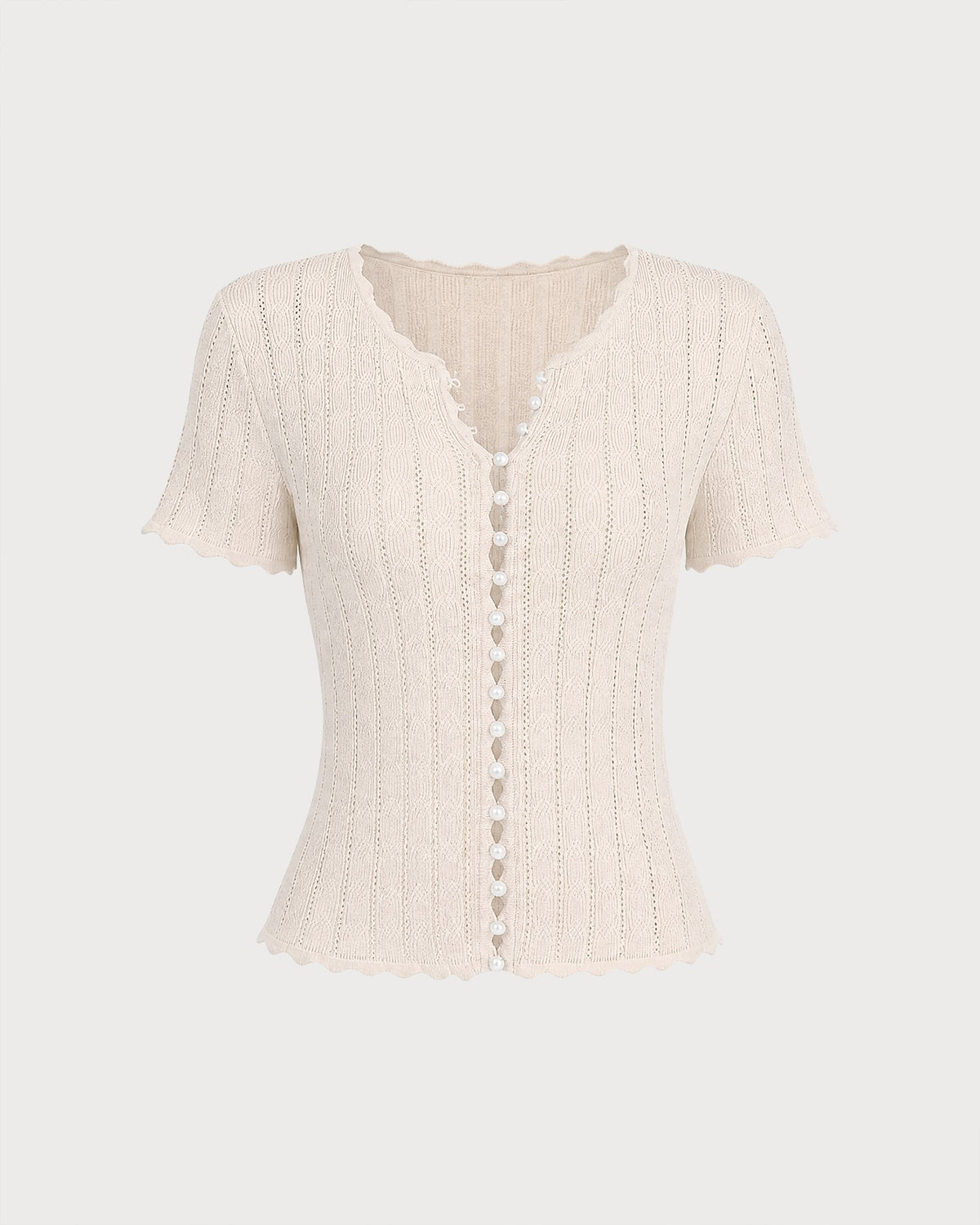 Pull en maille couleur abricot à découpes et boutons