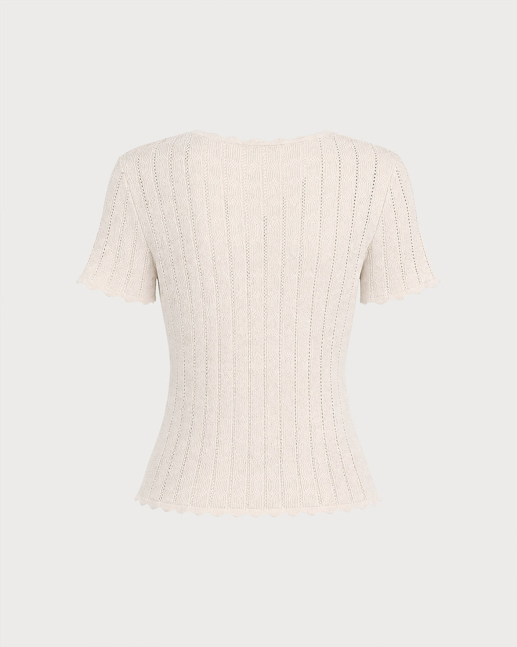 Pull en maille couleur abricot à découpes et boutons