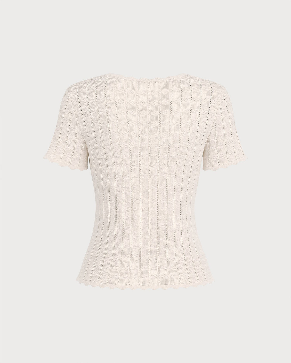 Pull en maille couleur abricot à découpes et boutons